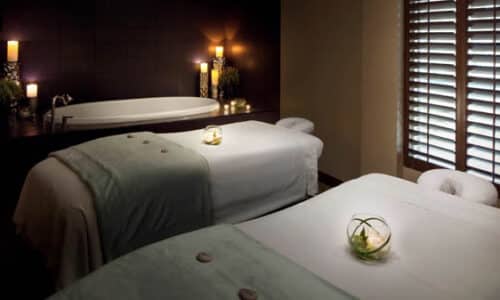 Softly lit spa room with 2 massage tables and a white porcelain bath at the Westin Hilton Head, SC